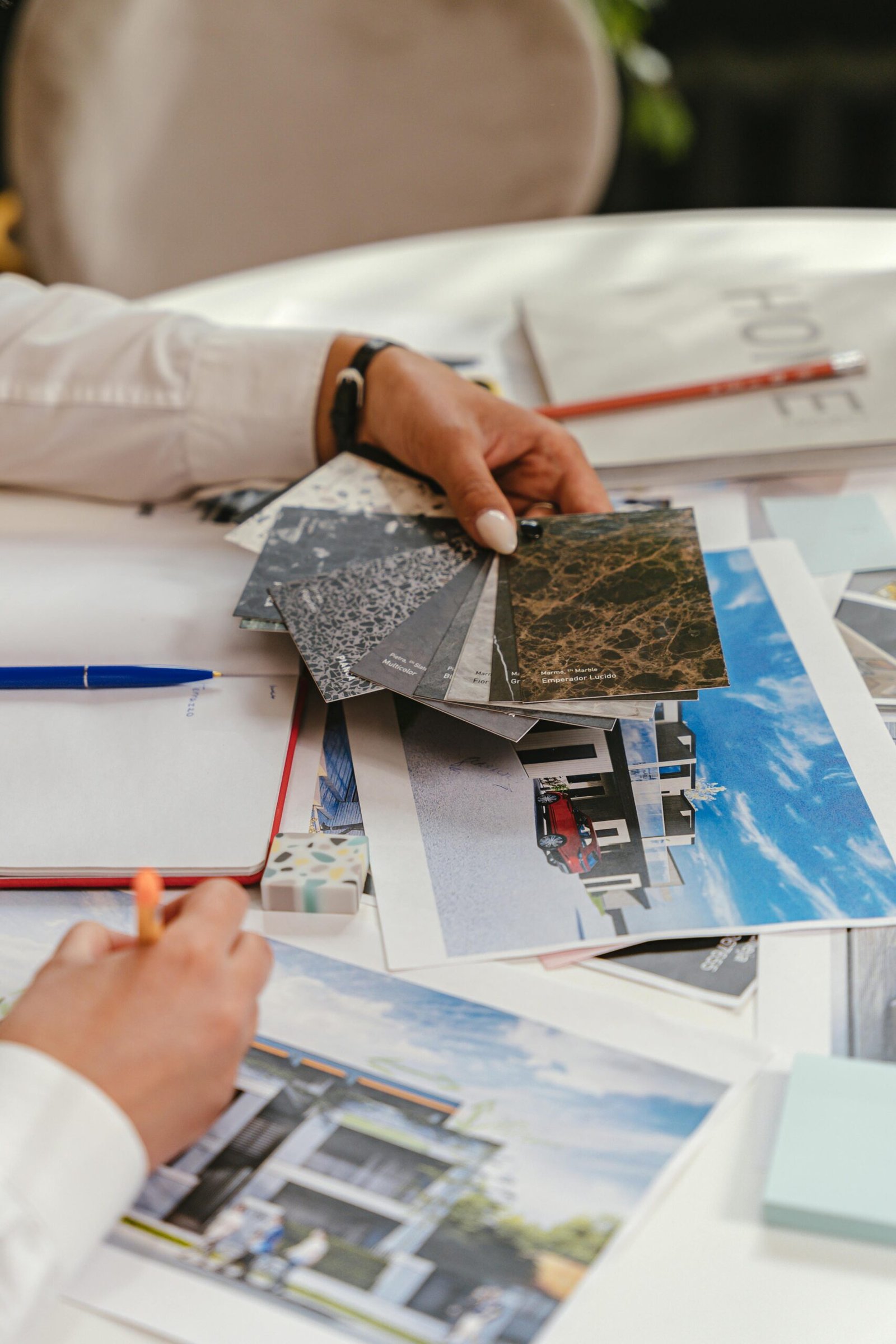 Close-up of architect examining materials and blueprints for project design.